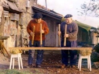 Traditional basque performers jointly playing the txalaparta