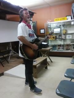 Tom Breiding playing at the Okemah Historical Society, during 2019 Woody Fest